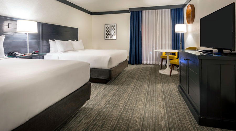 Two beds next to window with airport view.